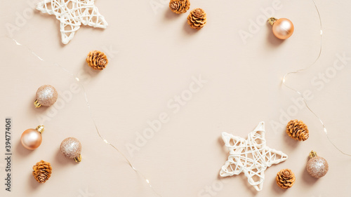 Cozy Christmas decorations on pastel beige background. Flat lay, top view. Elegant Xmas background.