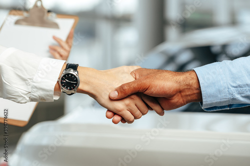 Female and male businesspeople handshake close up