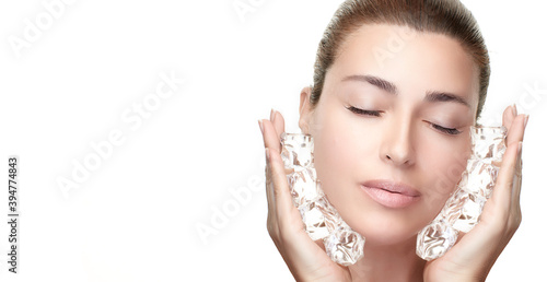 Spa Woman with healthy clean skin applying ice cubes on face. Cold Beauty Treatments. Beauty face