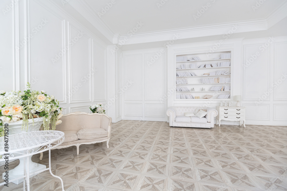 Luxury white interior of living spacious room with elegant chic furniture and high windows. Luxury white interior of living spacious room with elegant chic furniture and high windows.