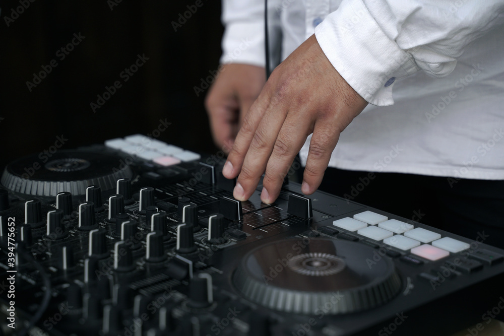 DJ at the remote at a party DJ at the remote at a party