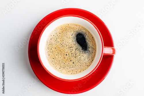 Coffee espresso in red cup. Coffee cup on white background closeup. Morning, breakfast, energy, coffee break concept. Top view