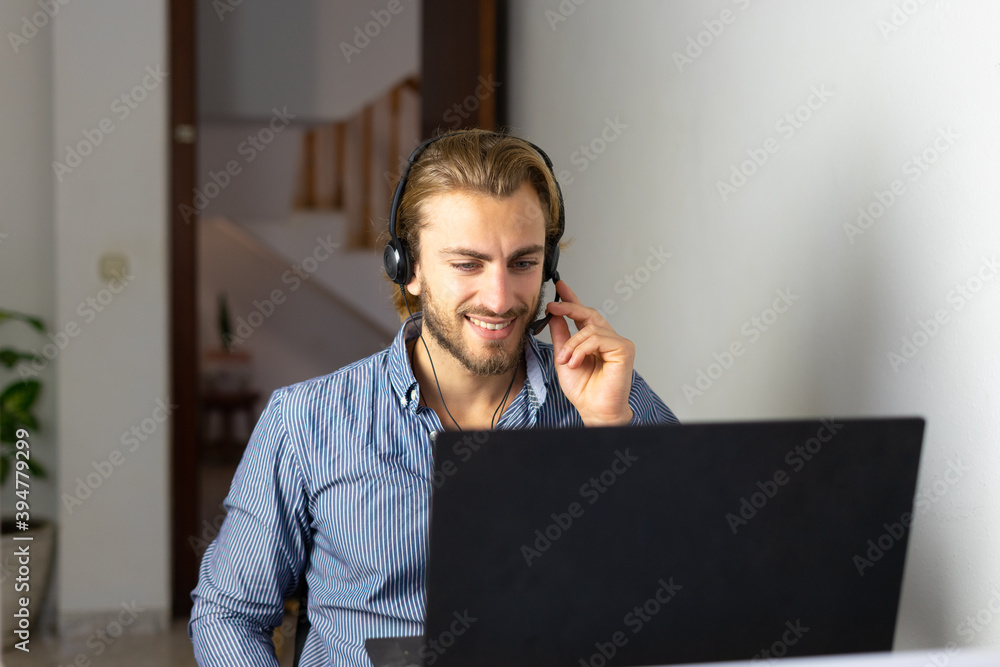 Male working from home with headphones Male working from home with headphones
