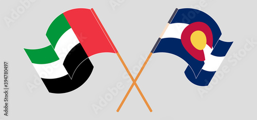 Crossed and waving flags of The United Arab Emirates and The State of Colorado