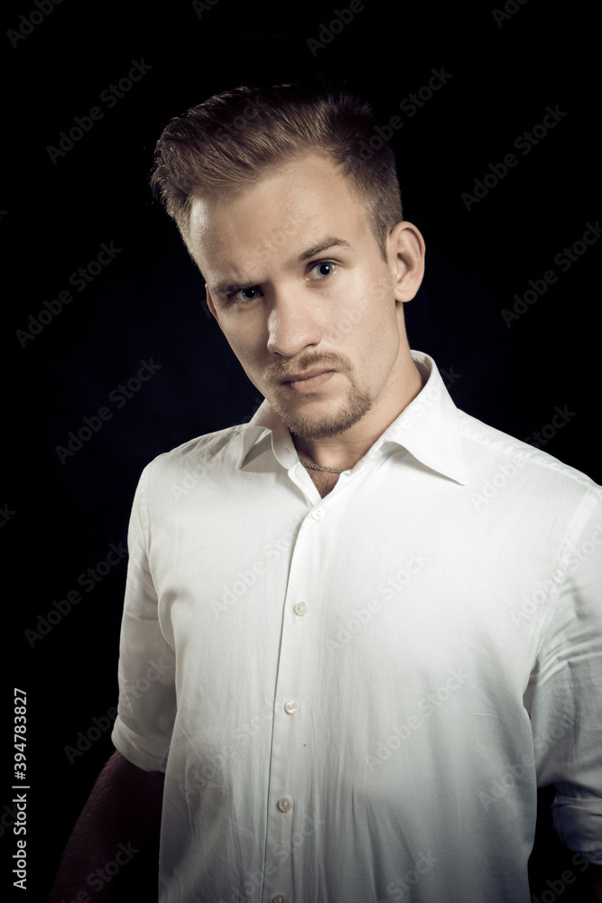 Naklejka premium Young man dressed in white shirt studio portrait