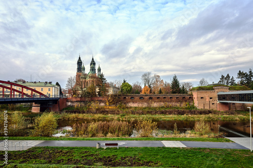 a modern footbridge, historic walls and gothic bell towers of the cathedral