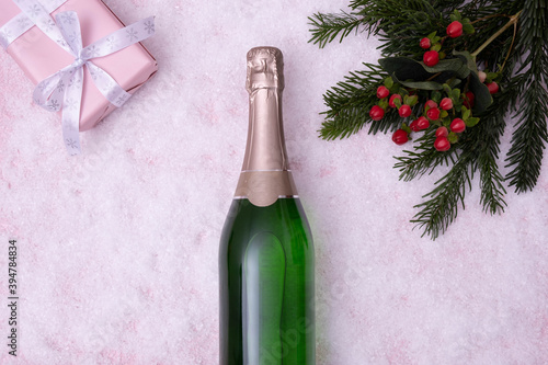 a bottle of champagne lies on a snow-covered table