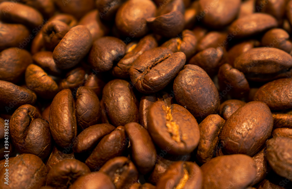 roasted coffee beans are scattered on the table. roasted coffee beans are scattered on the table.