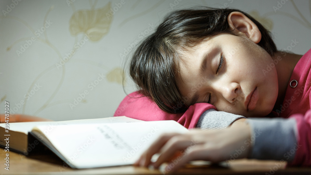 Girl fell asleep doing homework in the evening. Girl fell asleep doing homework in the evening.
