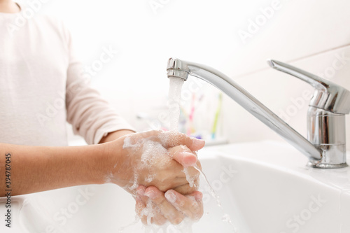 Washing hands in the bathroom.