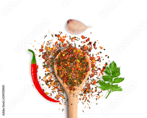 vegetable seasoning in a wooden spoon with garlic pepper and greens