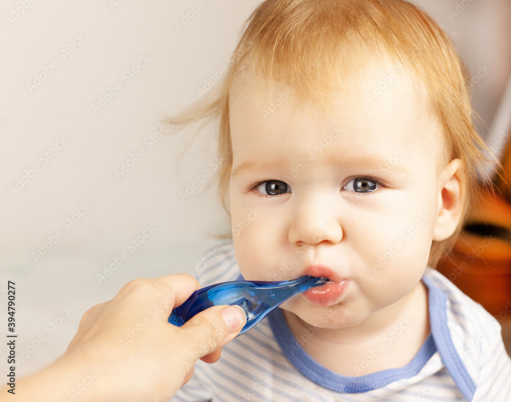 mom brushes her baby's teeth. Oral cavity care. First teeth. Teething. baby care mom brushes her baby's teeth. Oral cavity care. First teeth. Teething. baby care