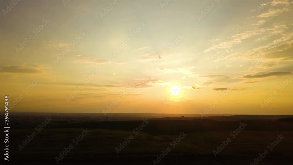 Aerial view of dark yellow sunset over farm fields in spring. Aerial view of dark yellow sunset over farm fields in spring.