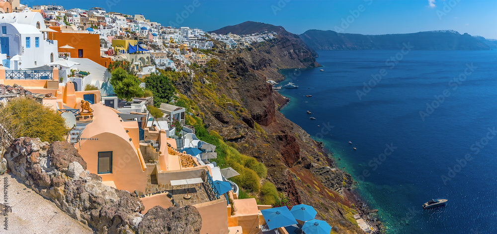 The buildings in the village of Oia, Santorini line the rim of the caldera in summertime