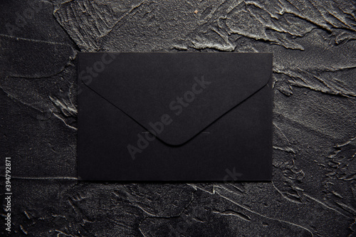 Black envelope on a dark background.