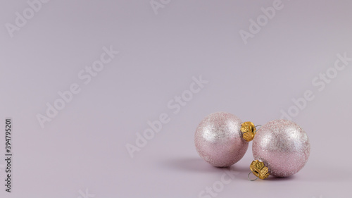 light pink christmas background and christmas ornaments. monochrome