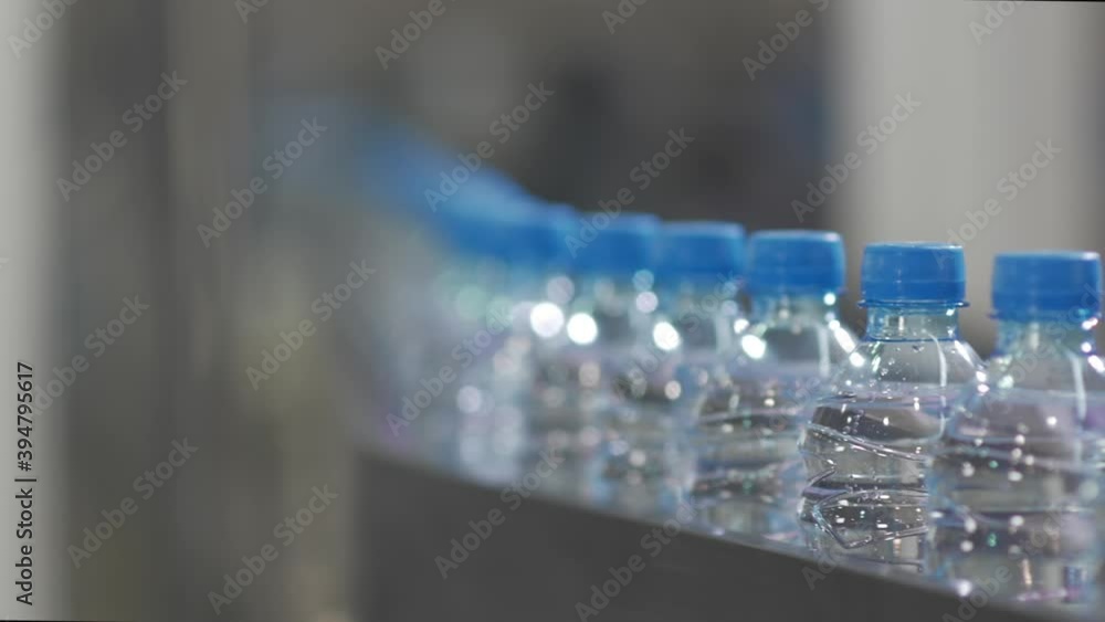 Conveyor line with plastic bottles. Industrial equipment. Factory for bottling water and drinks. Conveyor line with plastic bottles. Industrial equipment. Factory for bottling water and drinks.