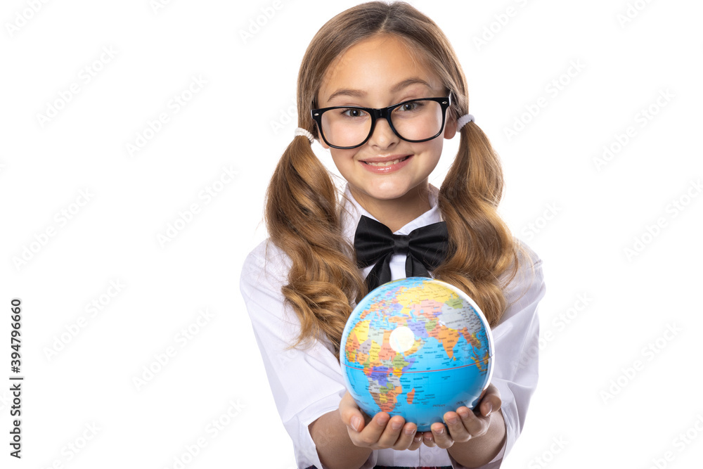 Schoolgirl girl in glasses, holding a globe in her hands, isolated on a white background. Schoolgirl girl in glasses, holding a globe in her hands, isolated on a white background.