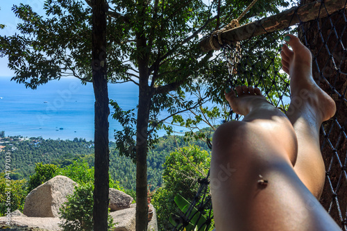 natural green island panoramic view, girls legs in hammock