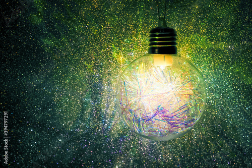 Christmas and New Year light, festive decoration. Decoration lamp in dark, light bulb decor, copy space. Garlands of burning light in bulb at night