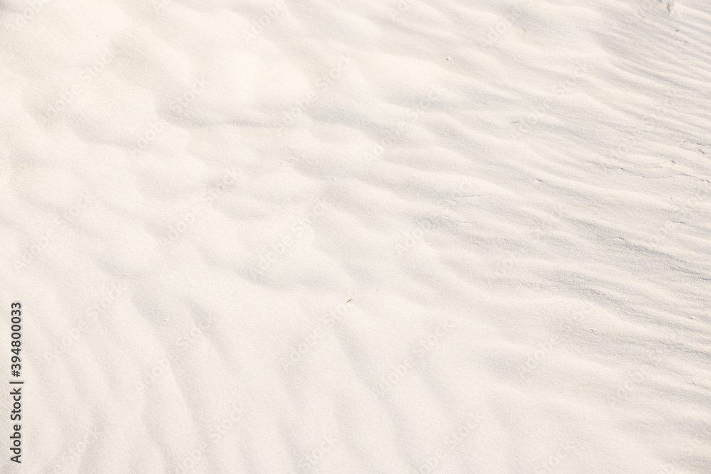 Background, sand, light, beige, wave, reflect, shadow, summer. Light shadows and patterns on the sand of dune. Beautiful sand`s background with graphics waves, shadows and lights. Background, sand, light, beige, wave, reflect, shadow, summer. Light shadows and patterns on the sand of dune. Beautiful sand`s background with graphics waves, shadows and lights.