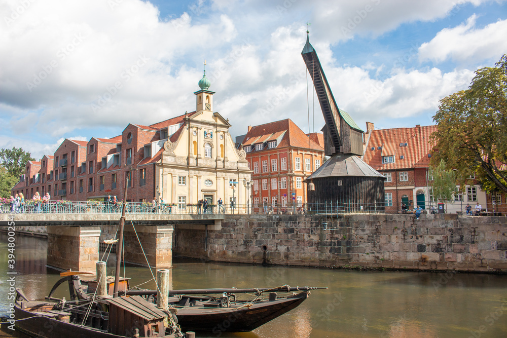 Fototapeta premium Panorama at the old market (Stintmarkt) old wooden crane and old department store Luneburg (in german Lüneburg) Lower Saxony (in german Niedersachsen) Germany