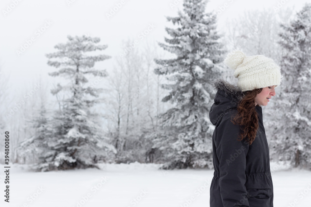 Girl walking in snow, frost and snow covered trees with fog, winter scene