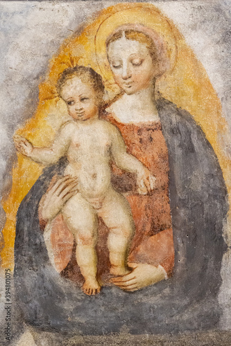 A fresco of the Virgin Mary with Infant Jesus in the "Santa Maria del Carmine" church (Holy Mary of Carmel) in Pavia, Italy. Shot in 2017.