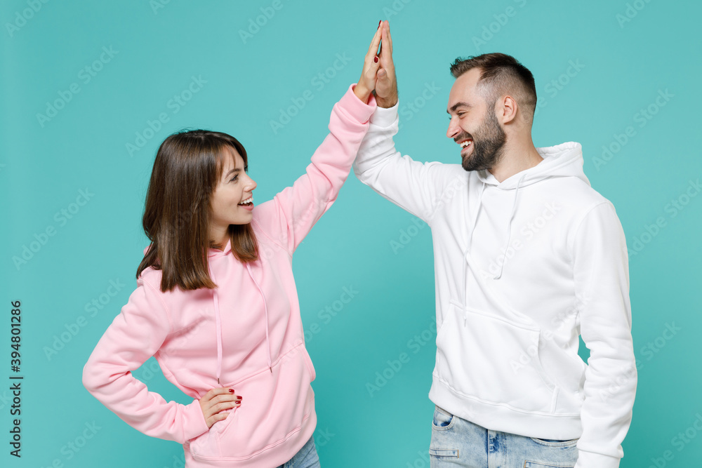 Smiling cheerful young couple two friends man woman in white pink ...