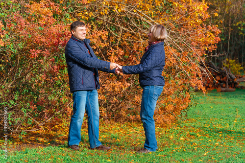 couple walking in autumn city park  happy people together  beautiful nature with colorful leaves