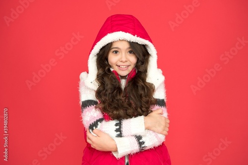 Posing for photo. thermal clothing. happy teen girl wear warm clothes. winter kid fashion. child with long curly hair in christmas aparrel. cold season activity style. childhood happiness photo