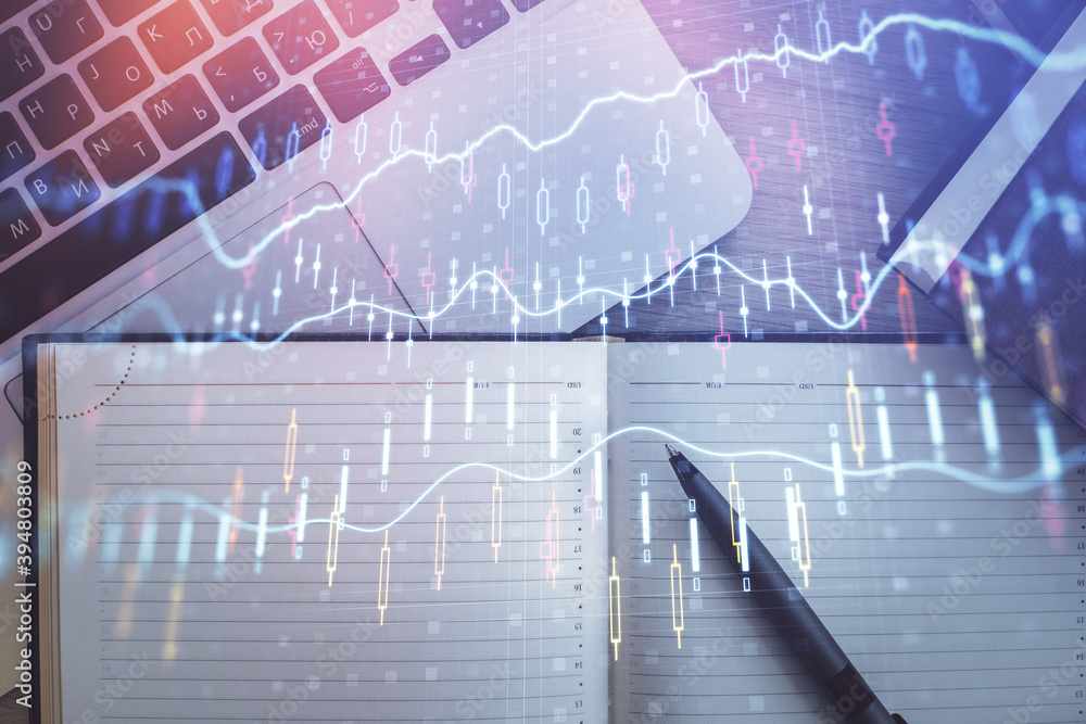 Stock market graph and top view computer on the table background. Multi exposure. Concept of financial education.