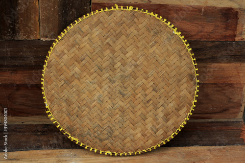 Tampah is a tool made of bamboo used to clean rice before washing and cooking photo