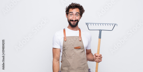 young man looking happy and goofy with a broad, fun, loony smile and eyes wide open
