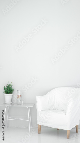 white chair in white meditation space with a table and a plant