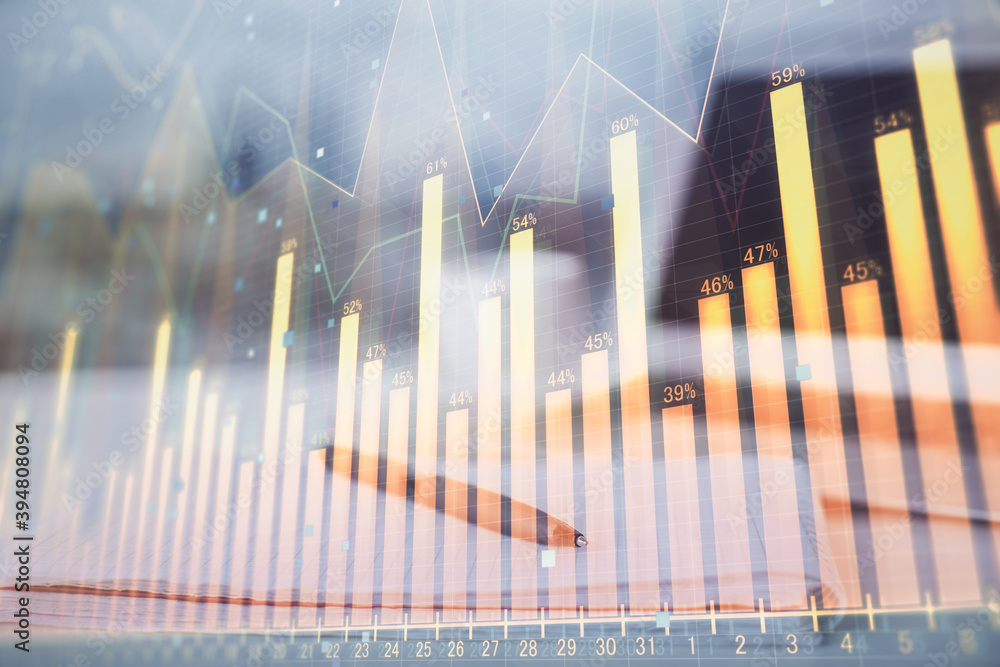 Double exposure of financial graph drawings and desk with open notebook background. Concept of forex market Double exposure of financial graph drawings and desk with open notebook background. Concept of forex market