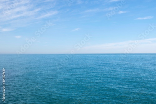 Blue ocean panorama with wave, calm sea and sky with clouds © Laura Guallar