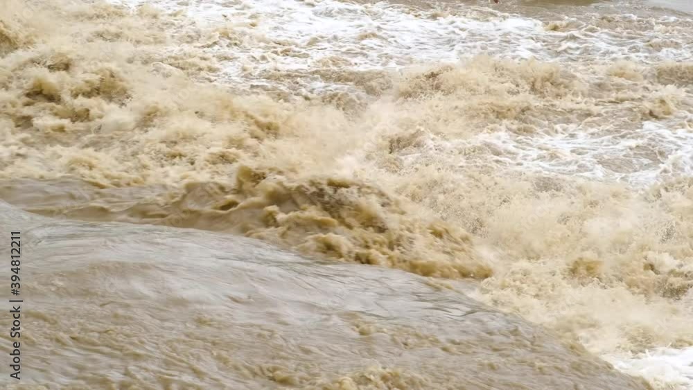 Dirty water of muddy river in flooding period during heavy rains in spring. Dirty water of muddy river in flooding period during heavy rains in spring.