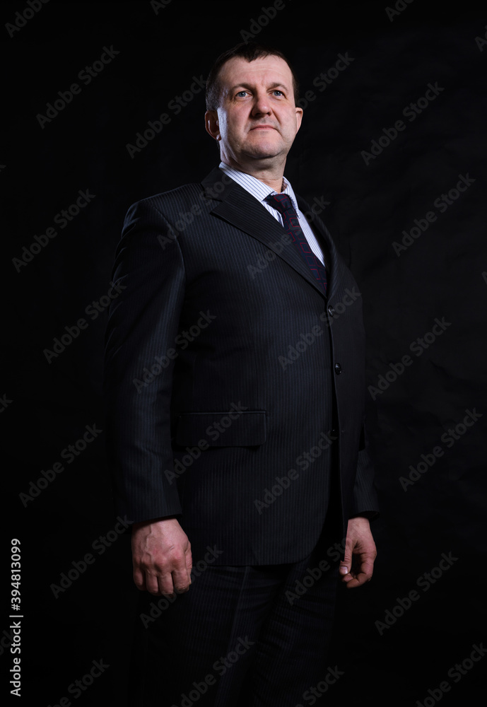 Middle aged solid man dressed in suit studio portrait Middle aged solid man dressed in suit studio portrait