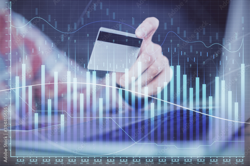 Double exposure of man hands holding a credit card and Forex graph drawing. Stock trading and digital fintech in Internet E-commerce concept. Double exposure of man hands holding a credit card and Forex graph drawing. Stock trading and digital fintech in Internet E-commerce concept.