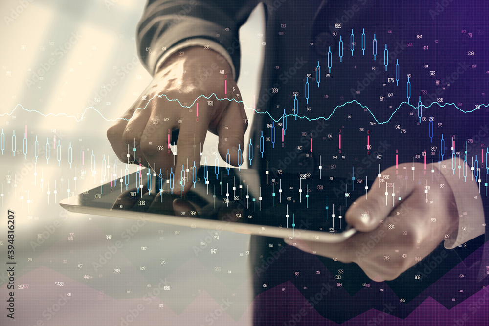 Fototapeta premium Double exposure of man's hands holding and using a digital device and forex graph drawing. Financial market concept.