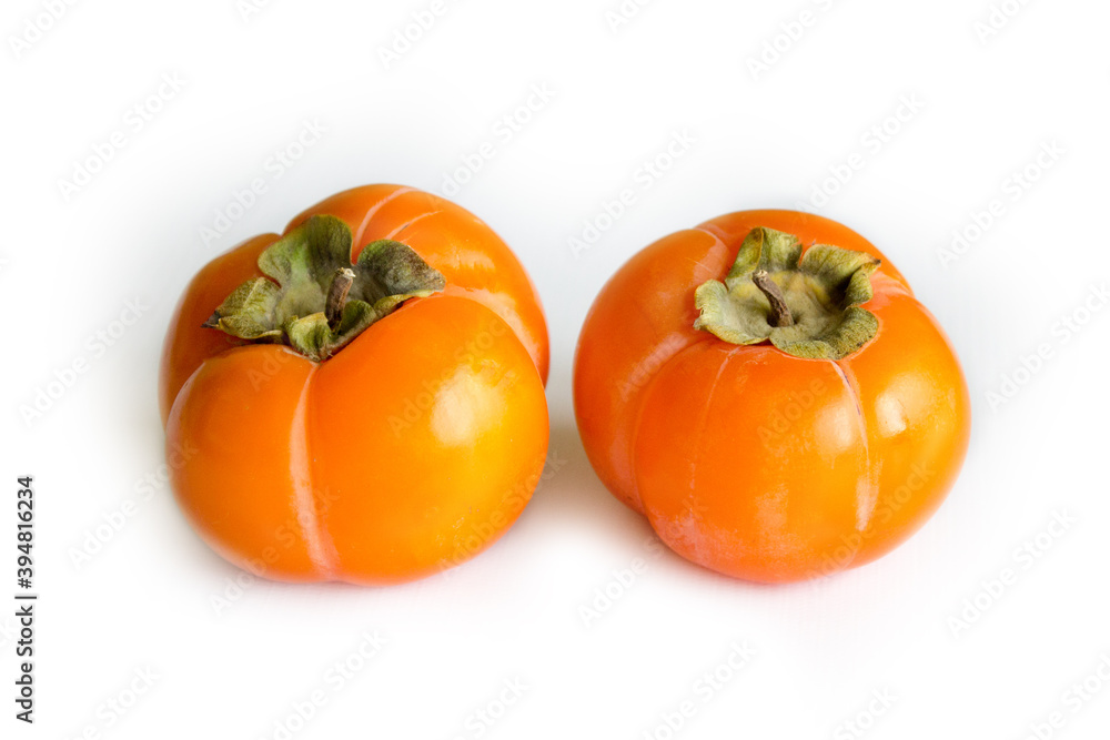 Ripe persimmon isolated on light background, seasonal winter fruit Ripe persimmon isolated on light background, seasonal winter fruit