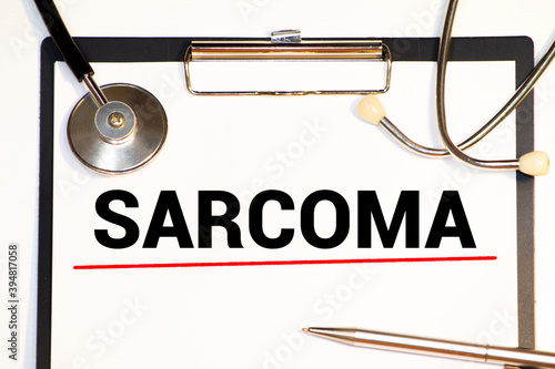 Diagnosis sarcoma in a medical form on the doctor desk photo