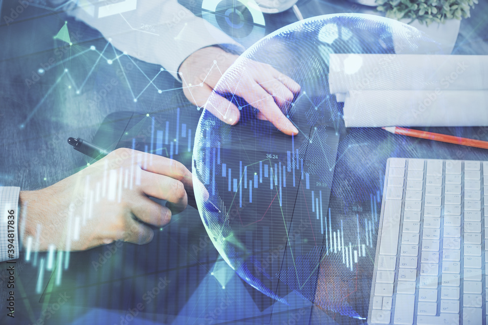 Double exposure of man's hands holding and using a phone and financial graph drawing. Analysis concept. Double exposure of man's hands holding and using a phone and financial graph drawing. Analysis concept.