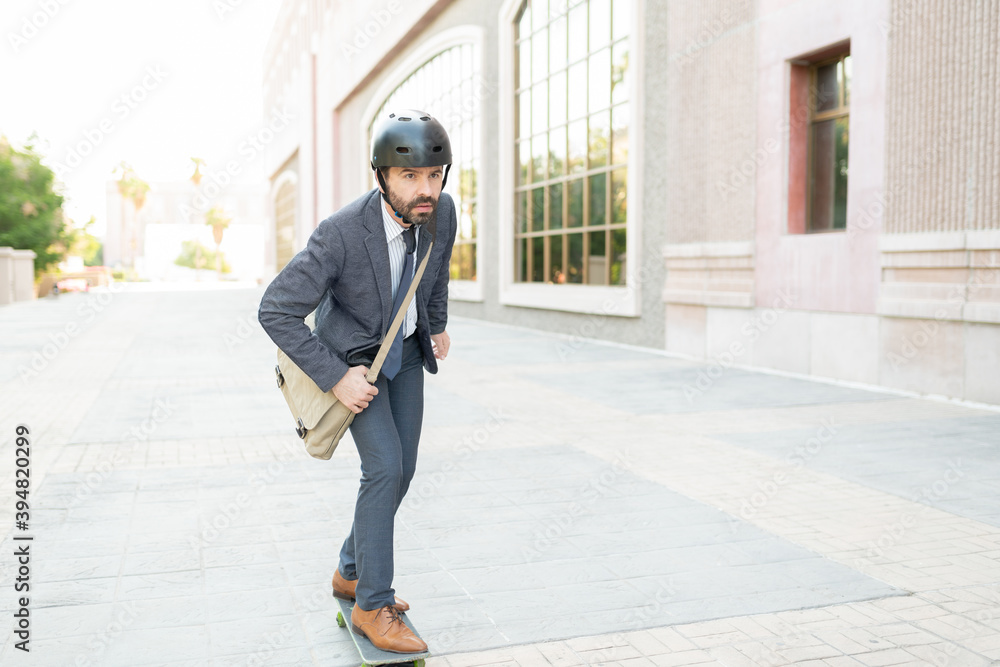 Professional man with a safety helmet riding a skateboard Professional man with a safety helmet riding a skateboard