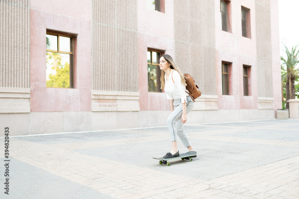 Caucasian female worker riding a skateboard in her commute to work. Pretty  adult woman trying an eco-friendly vehicle to get to her work Stock Photo |  Adobe Stock