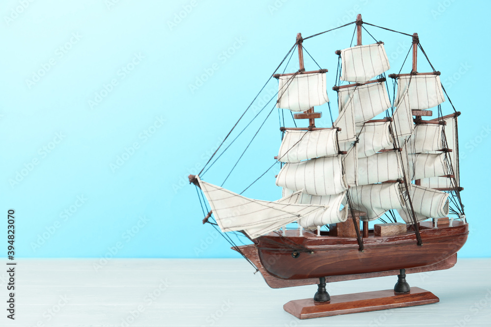 Beautiful ship model on white wooden table. Space for text