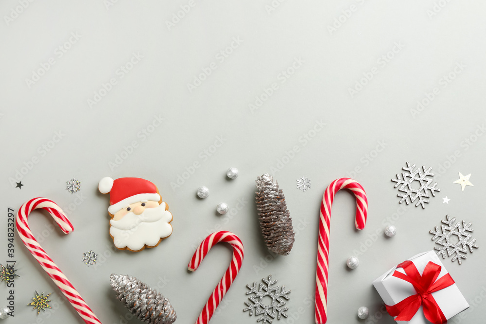 Flat lay composition with candy canes and Christmas decor on grey background. Space for text - obrazy, fototapety, plakaty 