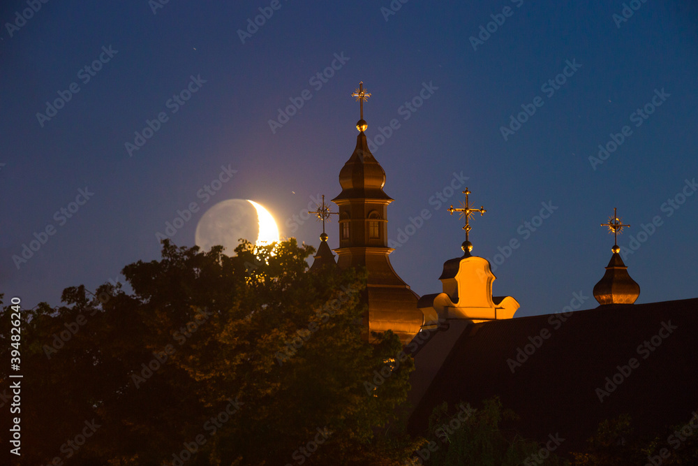 Moonset over old church