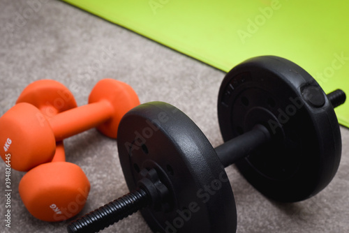 Fitness and weight training equipment with dumbbells and exercise mat
